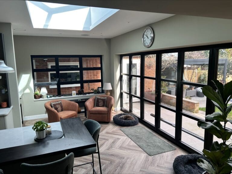 Completed living area with glazed doors and a roof lantern in a rear extension in Bilton, Rugby